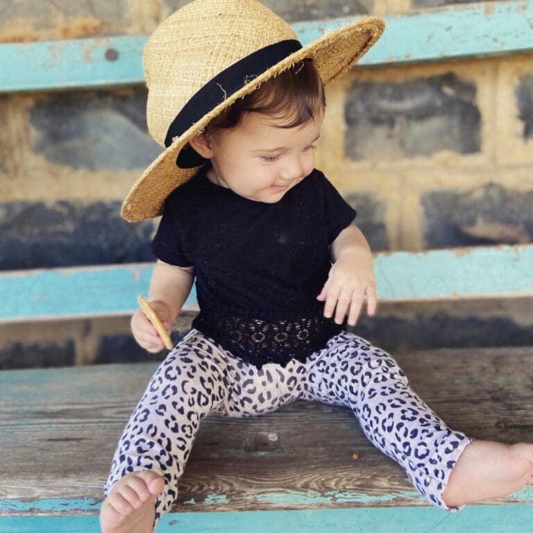 Summer with a hat, sitting on bench