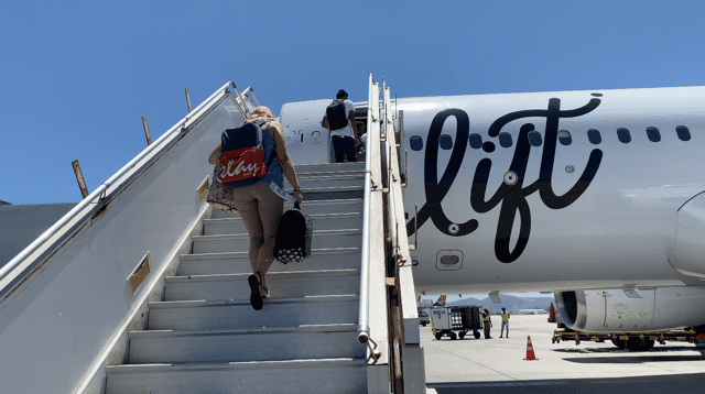 lady walking up stairs to lift plane