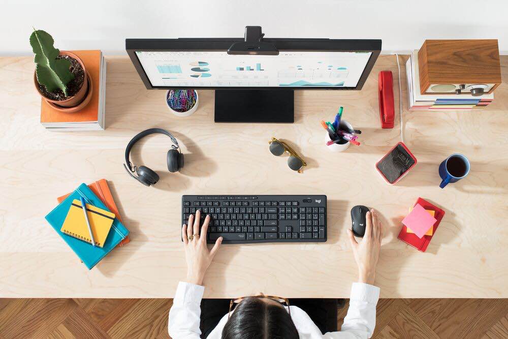 image of lady on her computer using Logitec