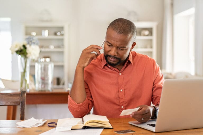 Man sitting at his desk paying bills