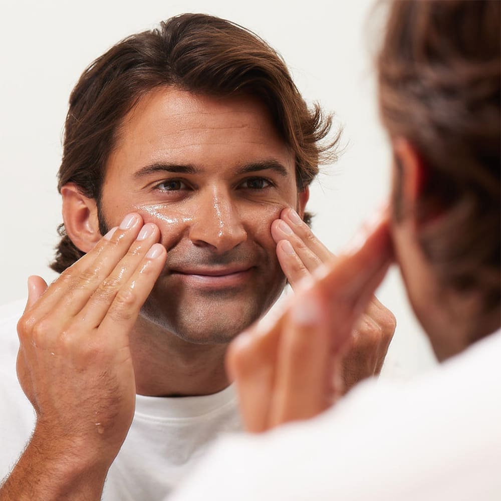 man cleaning his face