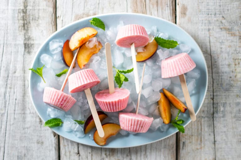 frozen plum lollies in a bowl of ice