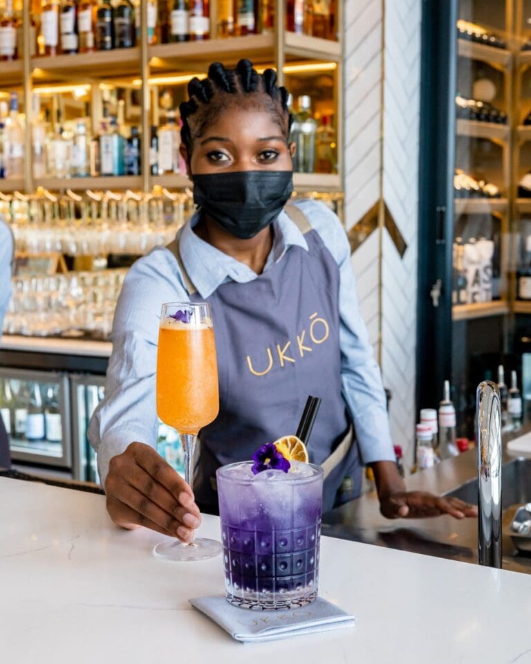 Bar lady serving a cocktail