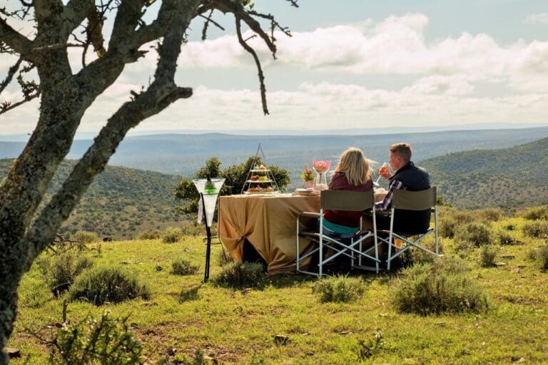 Couple enjoying sundowners in the bush