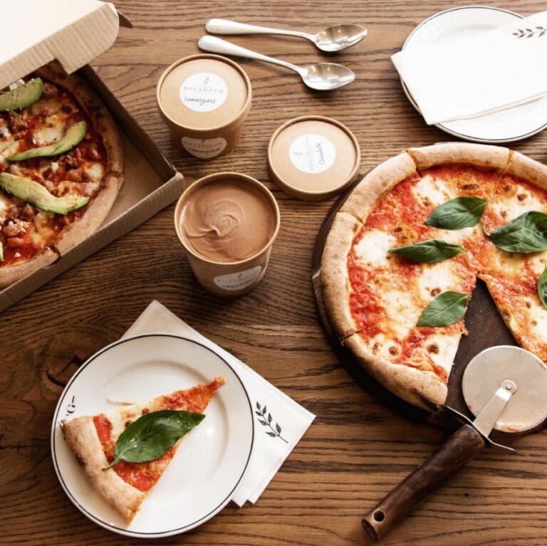 Neapolitan style pizza and coffee on a brown table