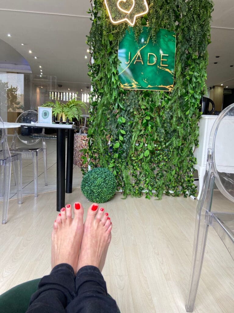 Ladies toes in front of garden wall