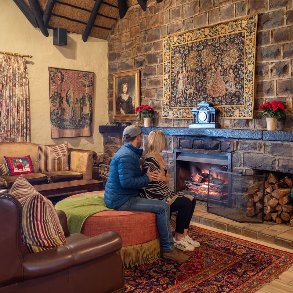 Couple sitting in front of a fireplace