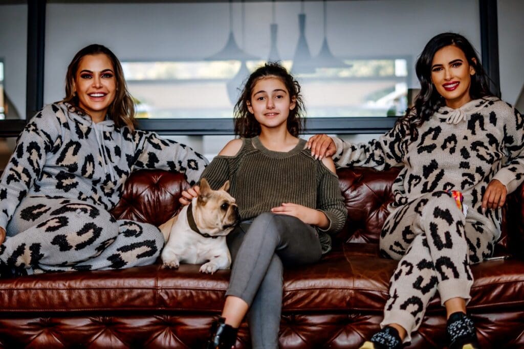 Girls and dog on a sofa at The Capital Hotel, Apartments and Resorts