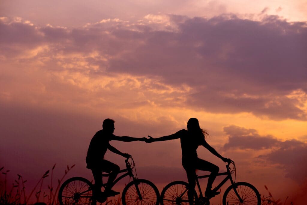 Couple riding a bike at sunset relationships