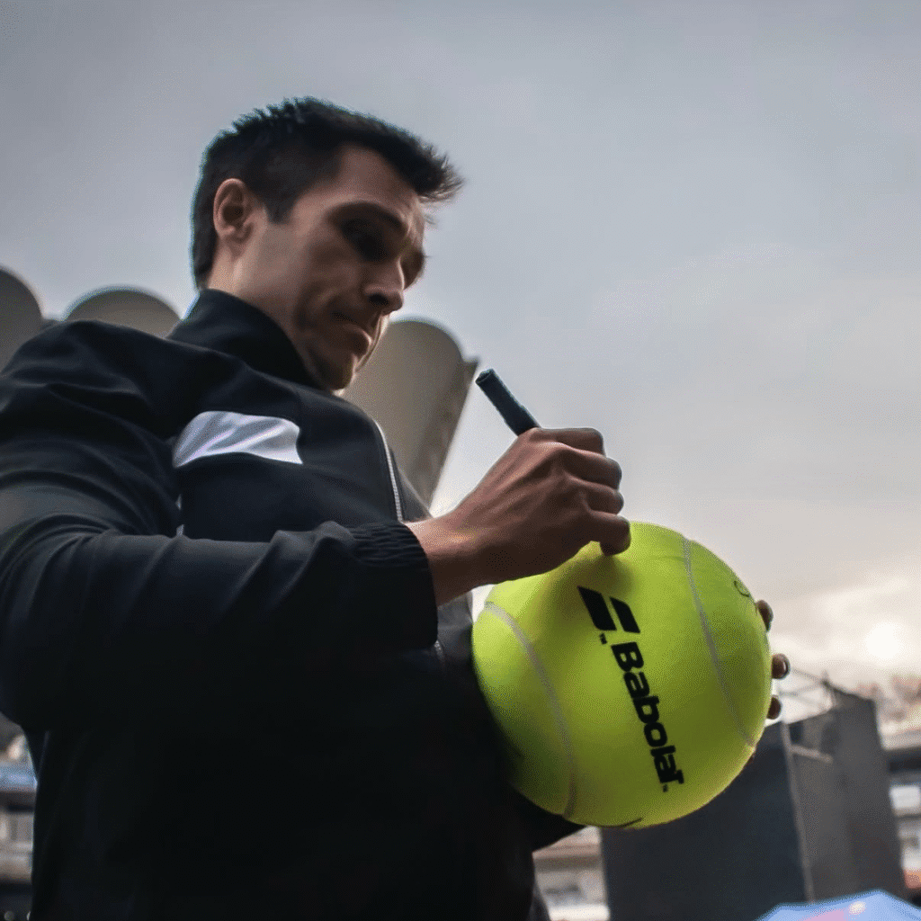 Bela signing a fan’s ball at the SA Invitational