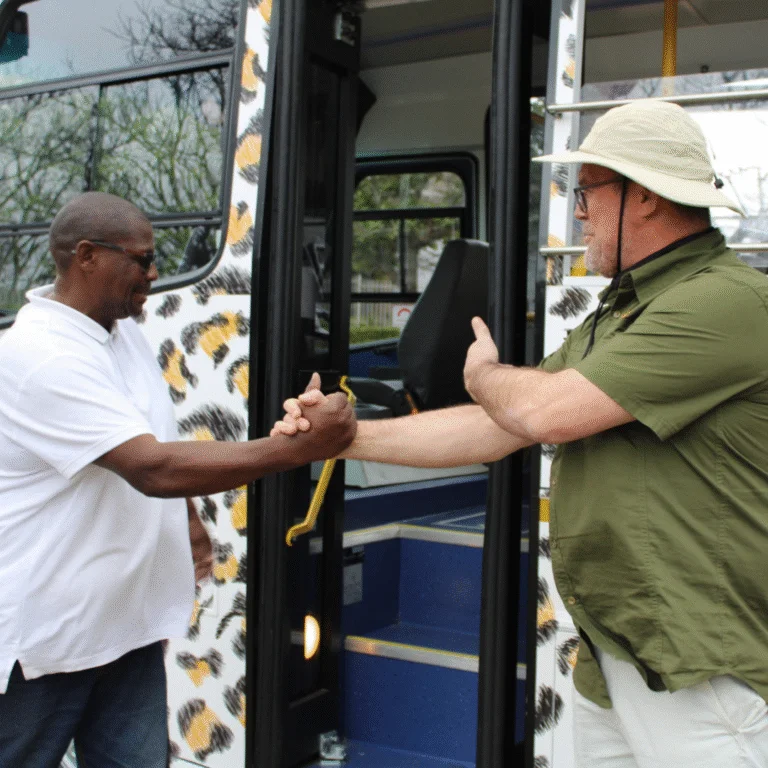 City Sightseeing Urban Safaris Driver and Passanger shaking hands