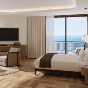 The Cole Bedroom overlooking the ocean, complete with wooden floors and neutral furniture