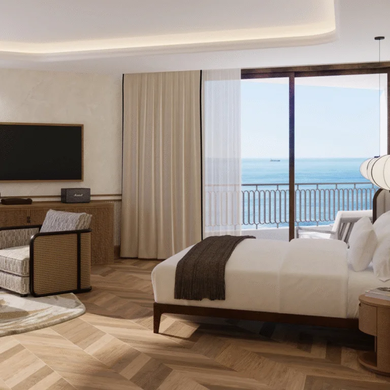 The Cole Bedroom overlooking the ocean, complete with wooden floors and neutral furniture