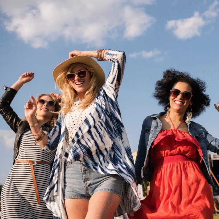 Women standing at a festival with sky in background
