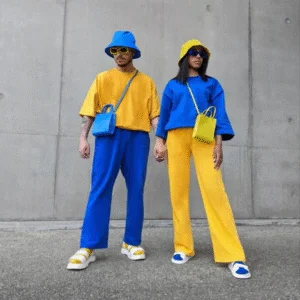 Two people standing in blue and yellow outfits, showing the Colourful Summer Trend