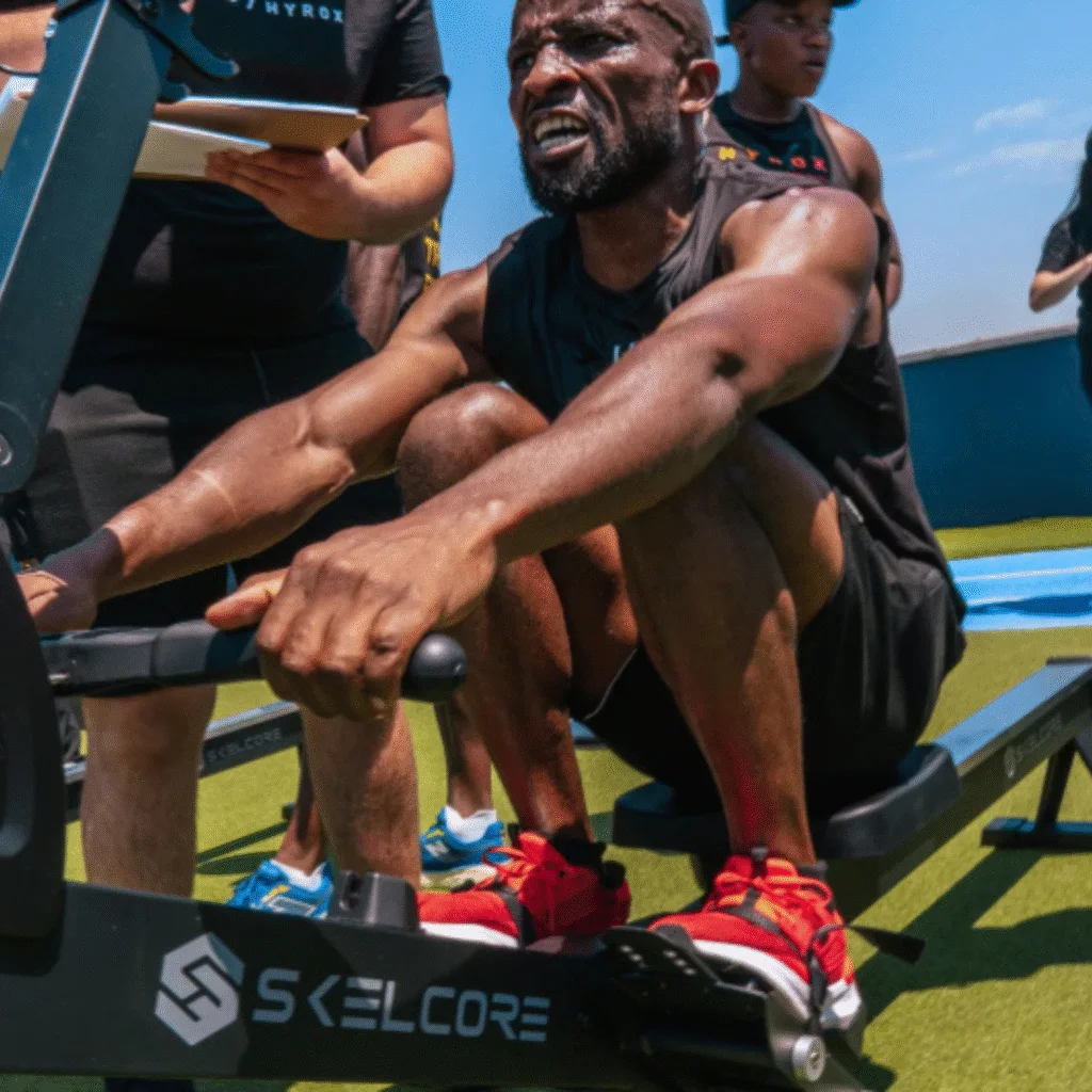 Man on rowing machine during Hyrox event
