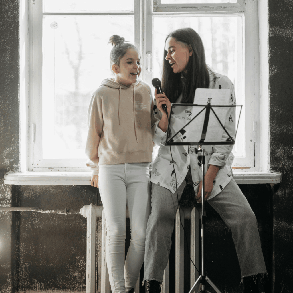 a young girl attending vocal lessons and singing