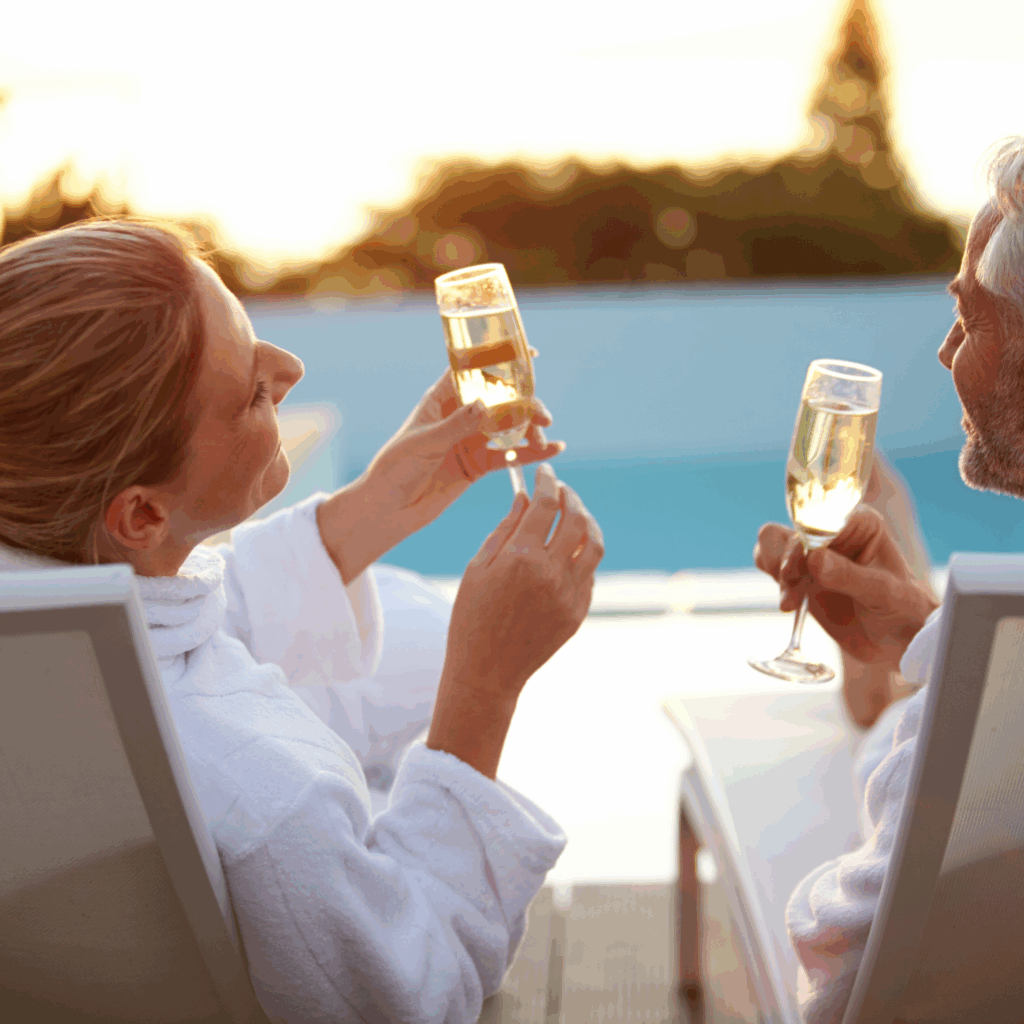 two people in robes drinking champagne
