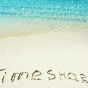 Timeshare written on the sand on a beach