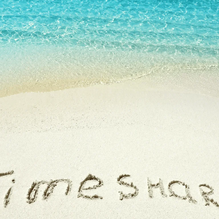 Timeshare written on the sand on a beach