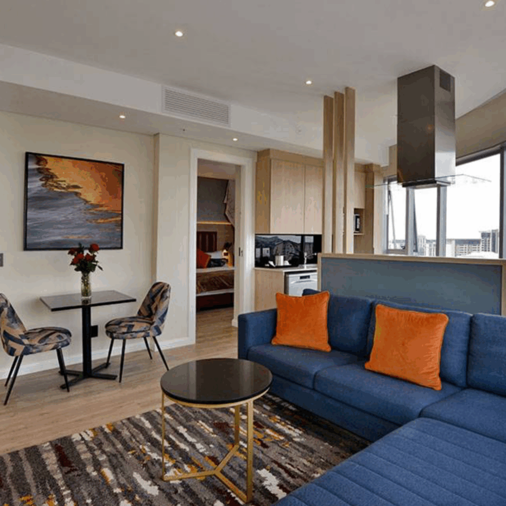 @Sandton Hotel Junior Suite Lounge with door into bedroom and table