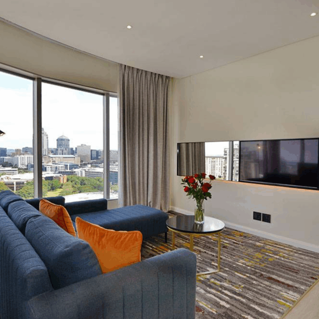 @Sandton Hotel Junior Suite Lounge with big windows and television