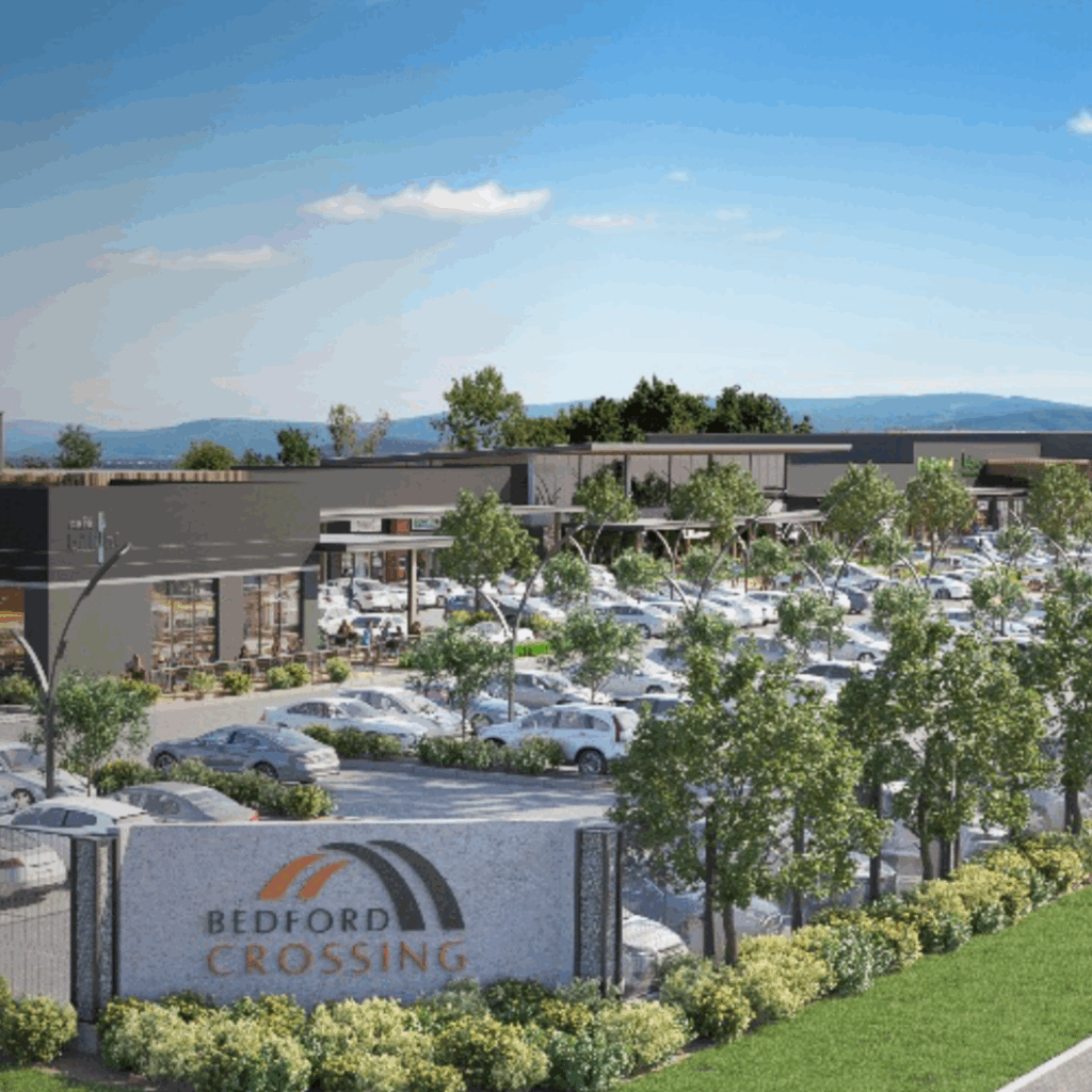 aerial view of Bedford Crossing shopping mall and hub with trees and cars