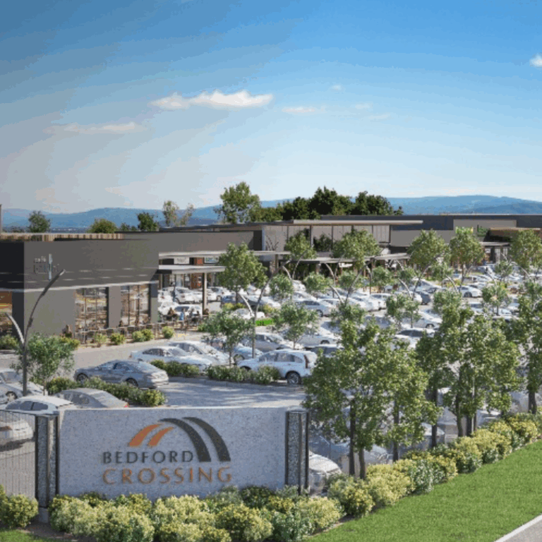 aerial view of Bedford Crossing shopping mall and hub with trees and cars