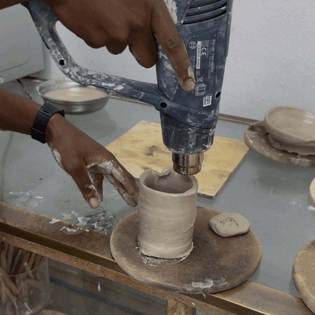 drying pottery on the wheel