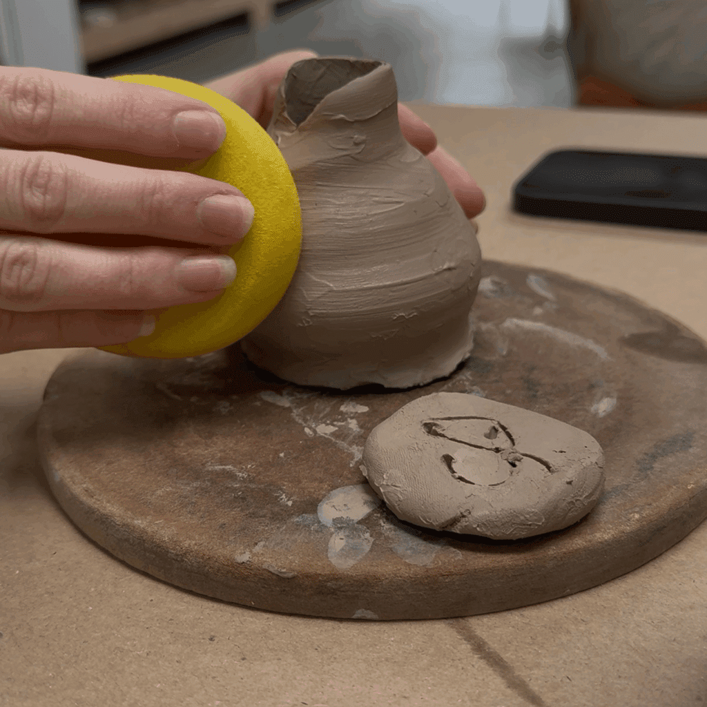 smoothing pottery on the wheel