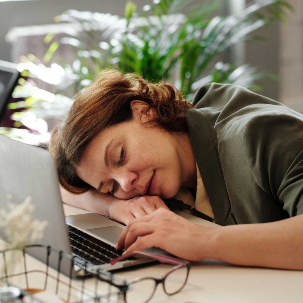 Momentum Multiply: How to Avoid Burnout. Girl Sleeping at Desk