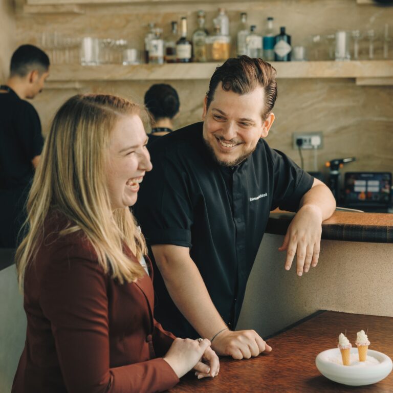 Ashley Jane Rosenberg and a chef at a restaurant in Dubai