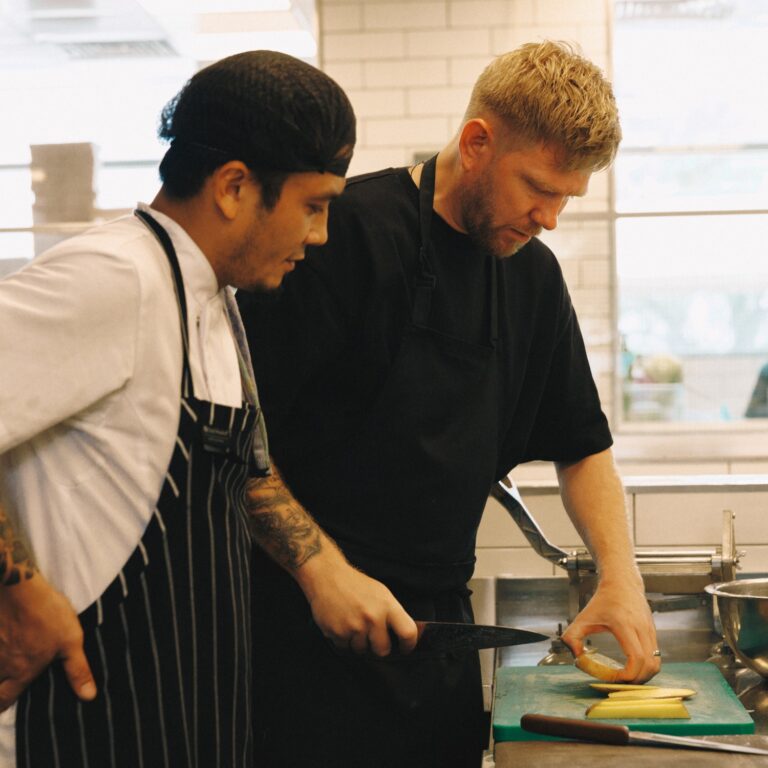 Kelvin Kelly working alongside a colleague in a kitchen