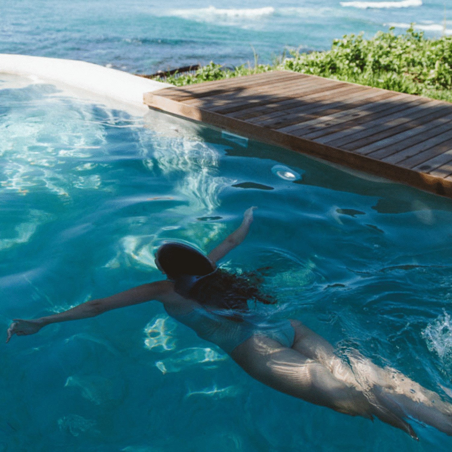 A swimmer in the pool at Sala Beach House.