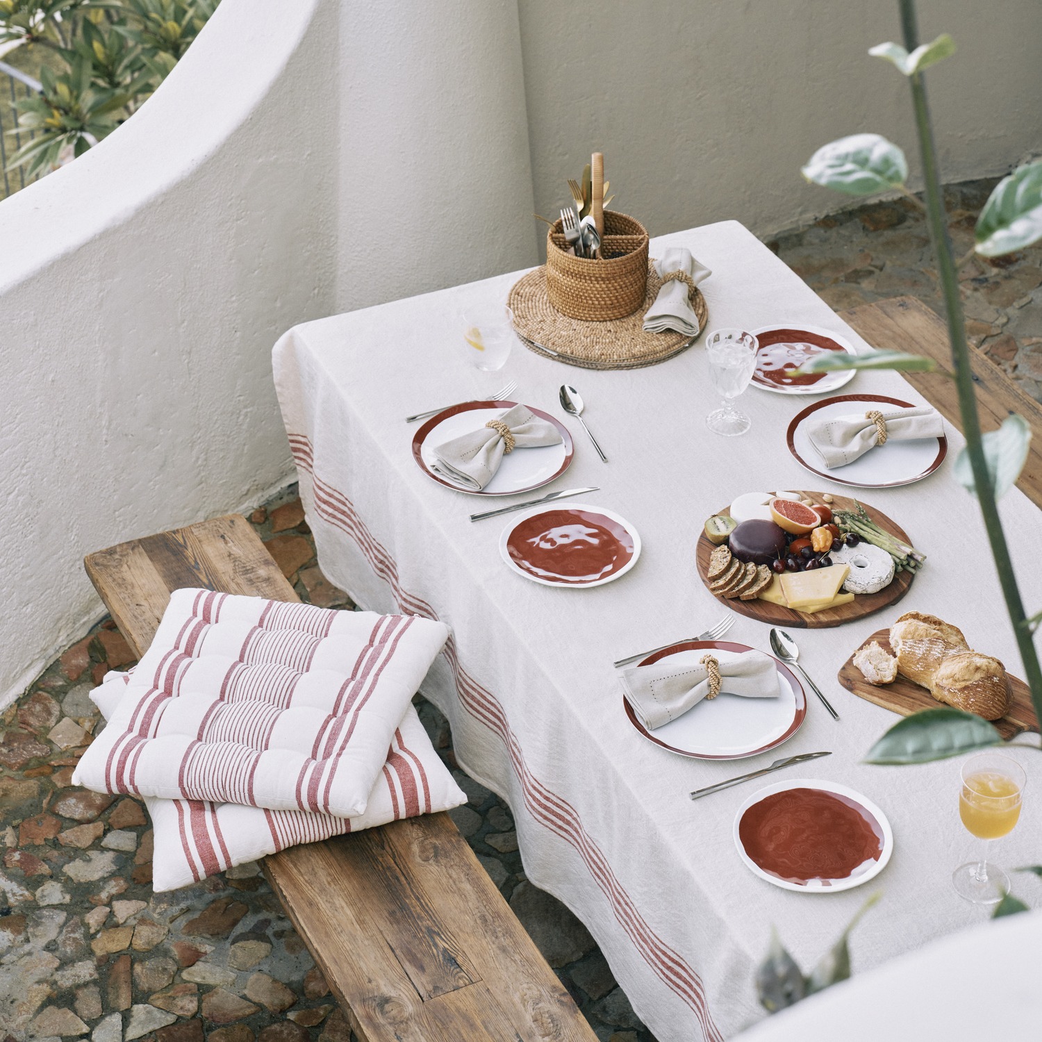 Woolworths summer tableware arranged on a white outdoor dining table